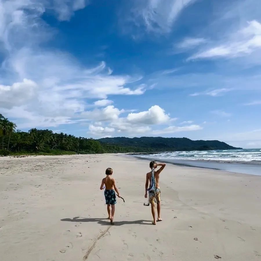 Kids walking the beach near Peace Villa