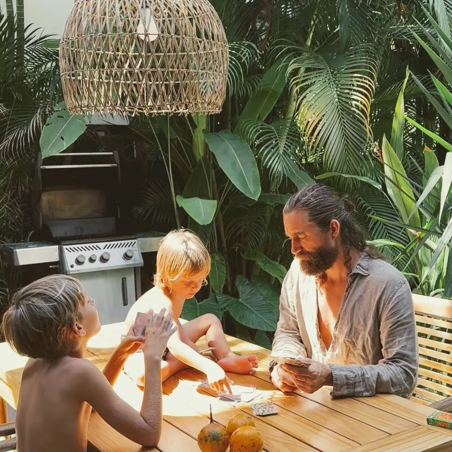 Family playing cards on the villa deck
