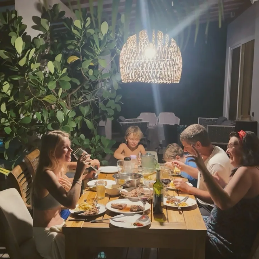 Friends and family sharing dinner on the villa deck
