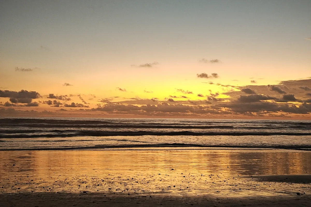 Golden sunset over the ocean at a Santa Teresa beach