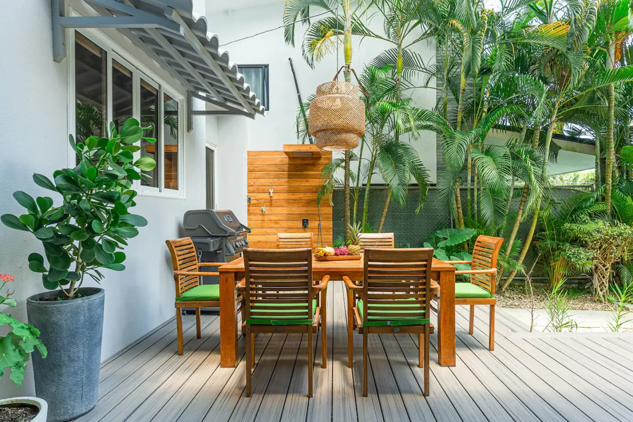 Outdoor dining deck surrounded by greenery